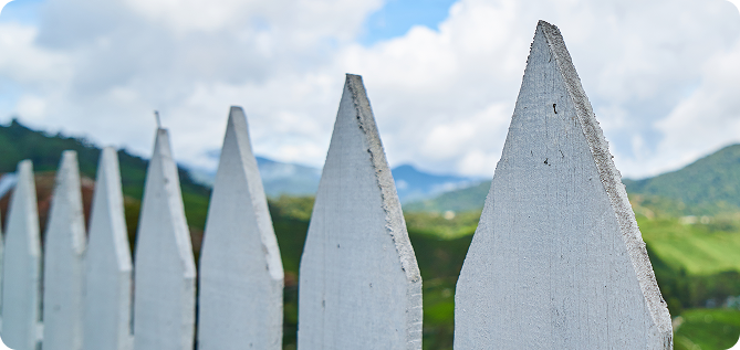 White picket fence in garden with flag